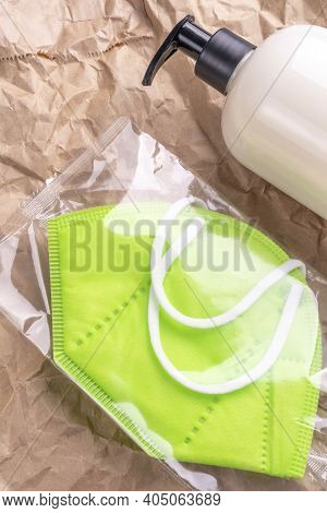 New Medical Protective Respiratory Mask In A Plastic Pack With A Gel Sanitizer With A Dispenser On A