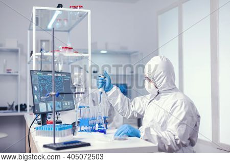 Researcher Testing Liquid Sample Uses Micropipette In Medical Lab. Chemist In Modern Laboratory Doin