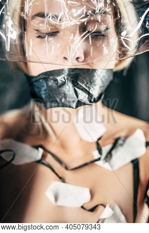 Female Conceptual Portrait. Environmental Pollution. Voiceless Woman. Plastic Recycling. Lady Taped 