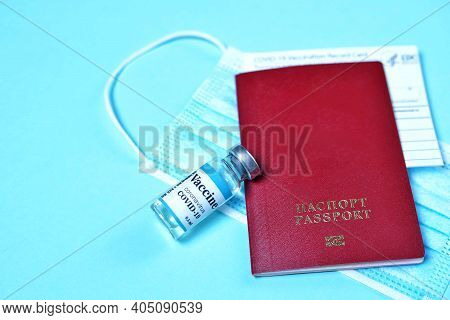 Covid-19 Vaccination Record Card, Red Burgundy Passport And Medical Mask. Immune Passport Or Certifi