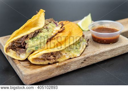 Mexican Culinary Favorite Shrimp Quesatacos Served On A Wooden Cutting Board And A Slice Of Lime Wit