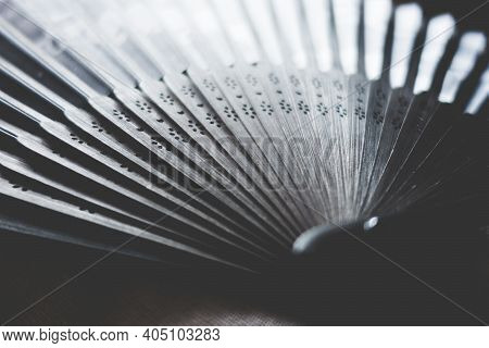 Traditional Black Hand Fand Closeup View. Abstract Background
