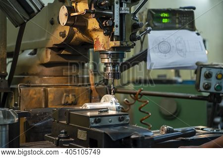 The Nc Milling Machine Drilling  At The Metal Part By Flat Drill Tools. The Shop Floor Operation By 
