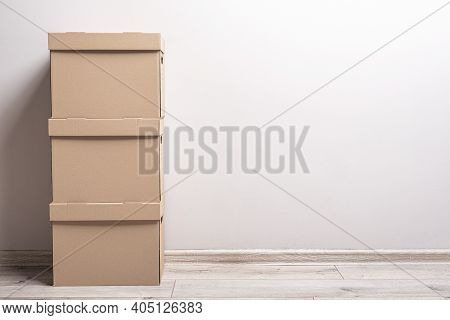 Empty Room With Cardboard Boxes On The Floor.