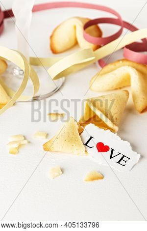 Cookies Shaped Like Tortellini With The Word Love Written On A Paper And A Glass Of Champagne With S