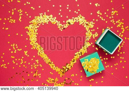 Place For Text Made Of Gold Sparkles In The Shape Of A Heart With Open Gift Box Covered With Gold Sp