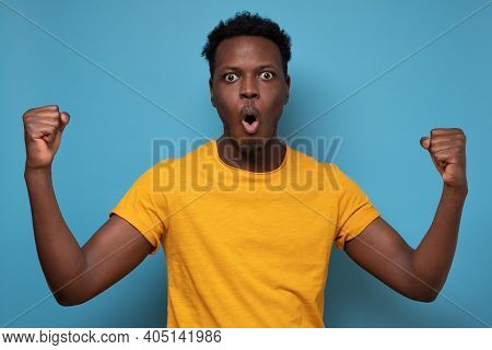 Happy Excited African Man Screaming And Celebrating Succcess With Two Fists Up