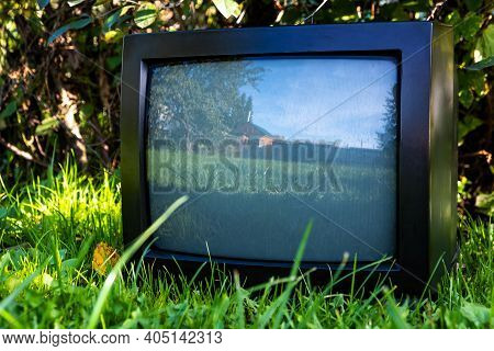 Old Analog Television Set On The Grass Outdoor