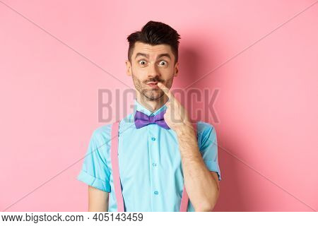 Intrigued Happy Guy Touching Lip, Looking At Camera Pensive, Making Choice What To Buy, Standing Ove