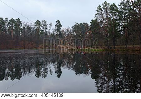 Cloudy Autumn Landscape. Scenic Pond In The Autumn Colored Forest. Trees Reflected In The Water. Aut