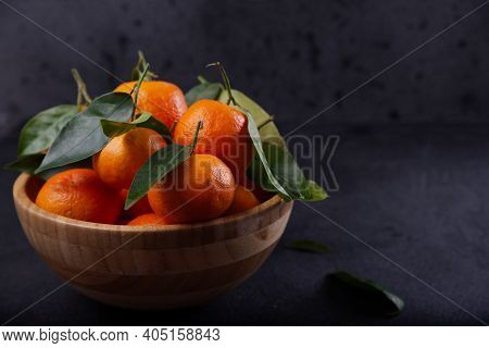 Freshly Harvested Tangerines From Organic Farming Exposed On Dark Background.