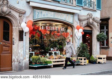Strasbourg, France - Feb 14, 2019: Single Woman Walking Near Fleurs Broglie La Fleuristerie Florist 