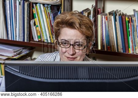 Portrait Of A Busy Woman Telecommuting At Her Desk At The Home. Working At Home Became An Important 