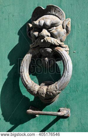Metal Face Door Knocker On Green Door, Pisa, Italy