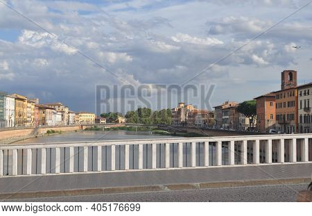 View From Bridge Over Arno River In Pisa, Italy. Pastel Houses.