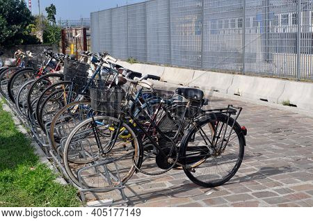 Bicycles Parked On The Side Of A Building.