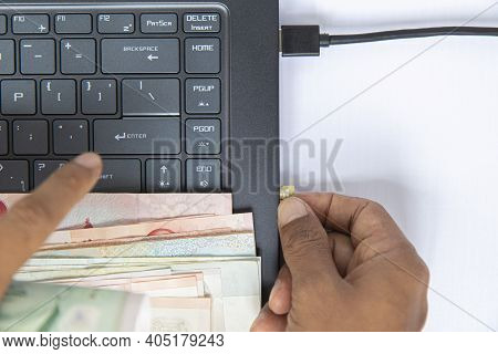 Top View Hand Put On Baknote And Black Keyboard On Notebook Have And A Memory Card Plugged Into Comp