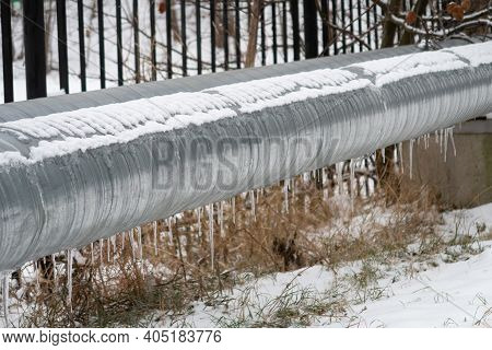 Snow Icicles On A Metal Pipe Of A Heating Main, Moscow Region