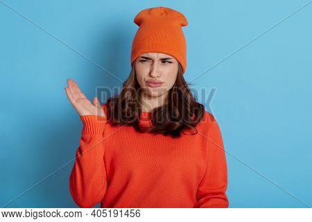 Portrait Of Displeased Young Female Feels Smell Stink, Has Discontent Expression, Dresses In Casual 