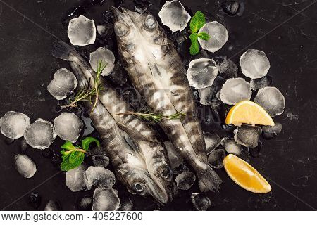 Fresh Pike Fish On Ice On A Black Table Top View. Wooden Rustic Background. Top View. High Quality P