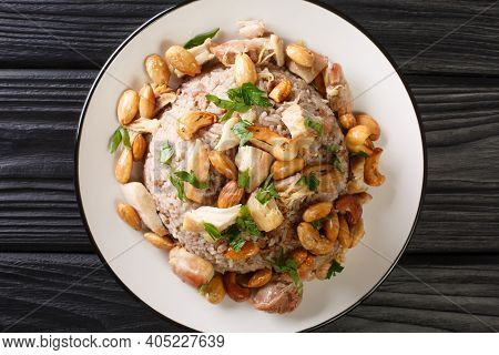 Authentic Cinnamon And Ground Beef Rice Recipe Topped With Chicken And Nuts Close-up In A Plate. Hor