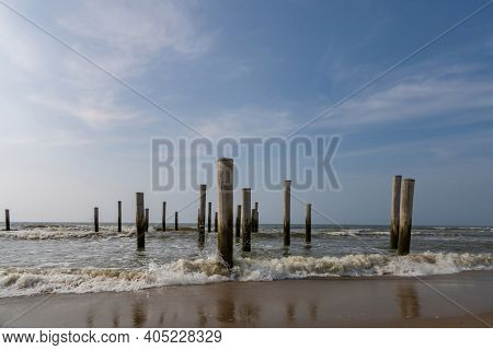 Long Exposure Seascape. Taken At The North Sea In Petten With The Pole Village In The Sea, Blue Sky,
