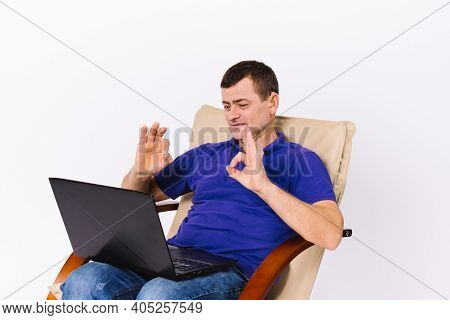 A Deaf Senior Man With A Laptop Shows A Sign To The Camera That Everything Is Fine While Sitting In 