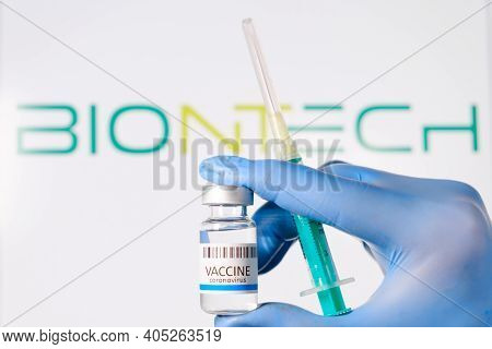 Biontech Ampule With Vaccine For Prevention Of Coronavirus, Sars-cov-2 And Syringe In Doctors Hand I