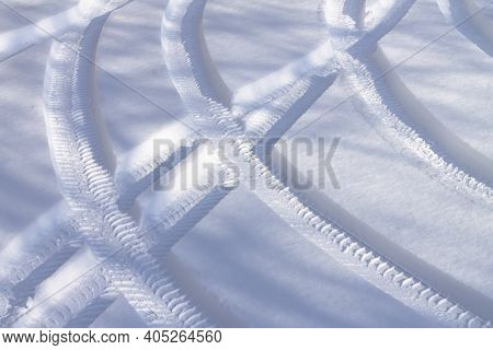 Car Tire Tracks Or Auto Footprint In Winted Snow Road Background