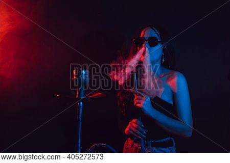 Hookah Atmosphere. The Girl Enjoys Smoking A Hookah, Sheesha.