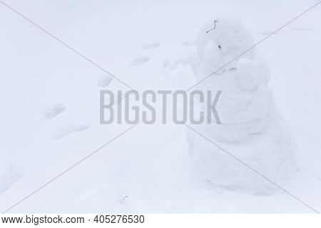 Snowman, Snow Woman Molded From Snow. Snowy Winter Concept. High Quality Photo