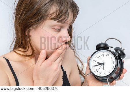 Shocked Woman With Alarm Clock Comes Late To Work Because She Oversleep - Oversleeping Concept