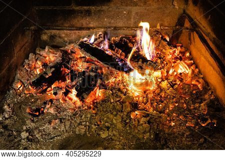 Smoldering Firewood And Hot Ash In Home Fireplace Close Up