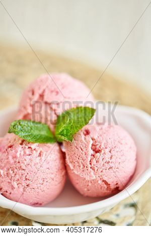 Strawberry Ice Cream With Mint Leaf. Three Balls In A White Bowl On A Vintage Table. Sorbet