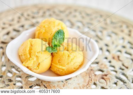 Mango Ice Cream With Mint Leaf. Three Balls In A White Bowl On A Vintage Table. Sorbet