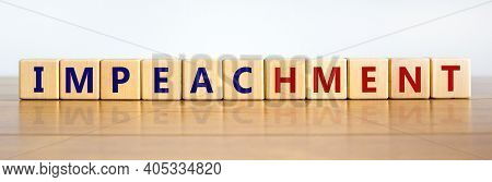 Impeachment Symbol. Wooden Cubes With The Word 'impeachment'. Beautiful Wooden Table, White Backgrou