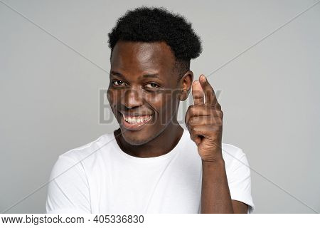 Hey, You. Cheerful Positive Young Afro American Man In Good Mood Smiling Broadly, Pointing A Finger 