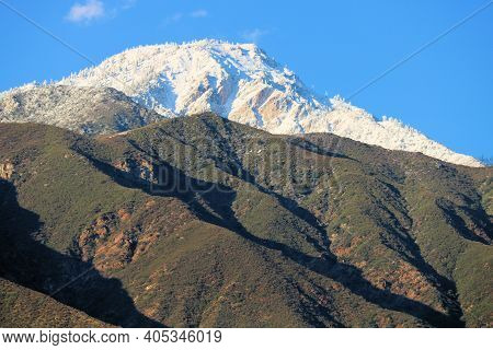 Barren Hills Covered With Chaparral Shrubs With Snow Capped Mountains Beyond Taken At Cucamonga Peak