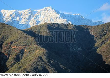 Chaparral Covered Hills With Snow Capped Mountains Beyond Taken At Cucamonga Peak In The Rural San G