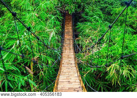 Traditional Construction Suspension Pedestrian Bridge Made From Natural Bamboo. Cable Bridge Crossin