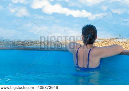 Woman Enjoying The Panoramic View From The Pool