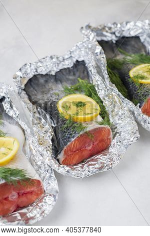 Fresh Raw Salmon Fillet Tail Part With Herbs, Lemon On A Light Background. Pescatarian Food Menu, Re