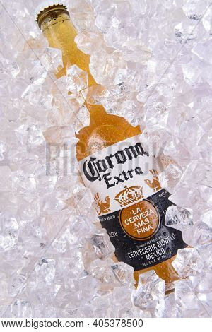 IRVINE, CALIFORNIA - MARCH 29, 2018: Closeup of a bottle of Corona Extra beer in ice. Corona is the most polular import in the USA.