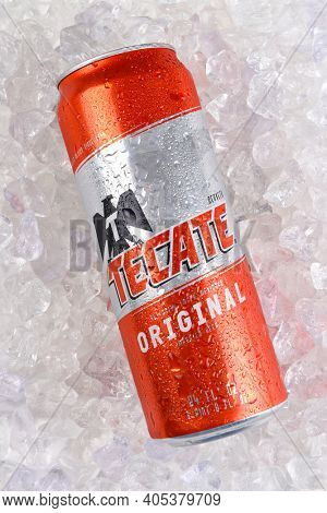 IRVINE, CALIFORNIA - MARCH 21, 2018: A Tecate Original Cerveza 24 ounce can on ice. Cuauhtemoc Moctezuma Brewery is a major brewer based in Monterrey, Nuevo Leon, Mexico, founded in 1890.