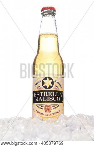 IRVINE, CALIFORNIA - MARCH 21, 2018: A bottle of Estrella Jalisco Beer in ice. Estrella Jalisco is a American Lager style beer brewed by Grupo Modelo.