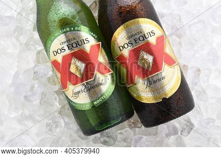 IRVINE, CA - JUNE 14, 2017: Dos Equis Blanca and Especial on ice. Two bottles the beer from Cuauhtemoc-Moctezuma Brewery in Monterrey, Mexico a subsidiary of Heineken International.