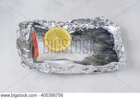 Fresh Raw Salmon Fillet Tail Part With Lemon On A Light Background. Pescatarian Food Menu, Recipe. R