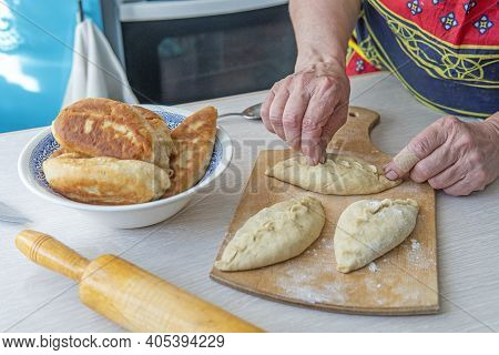 Grandma Cooks Pies. Home Cooked Food. Omemade Cakes Of The Dough In The Women's Hands. Process Of Ma