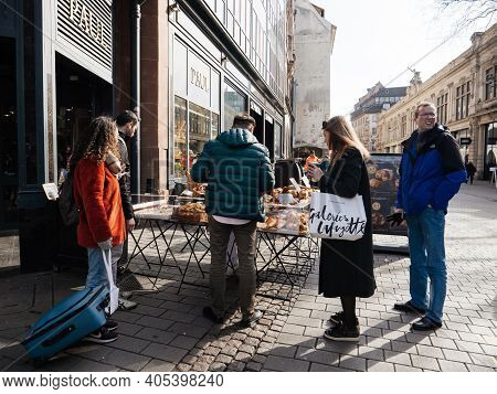 Strasbourg, France - Feb 23, 2018: French People Pedestrians Buying At The Outdoor Market Stall Bage