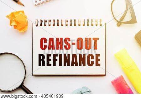 Text Cahs-out Refinance In Notebook On White Table With Office Tools.